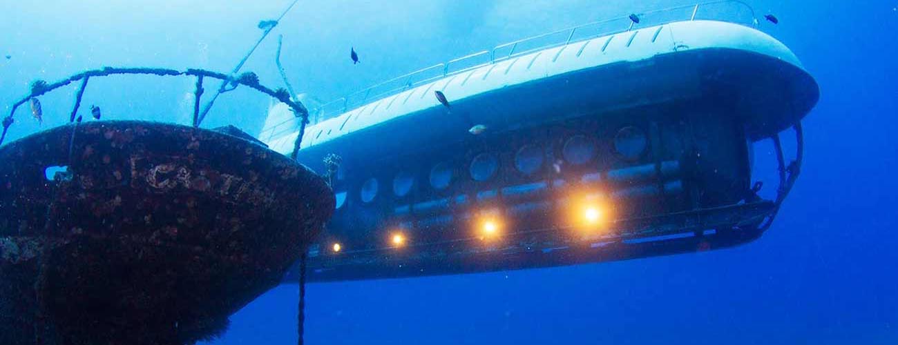 Image of Atlantis Submarine passing an underwater shipwreck