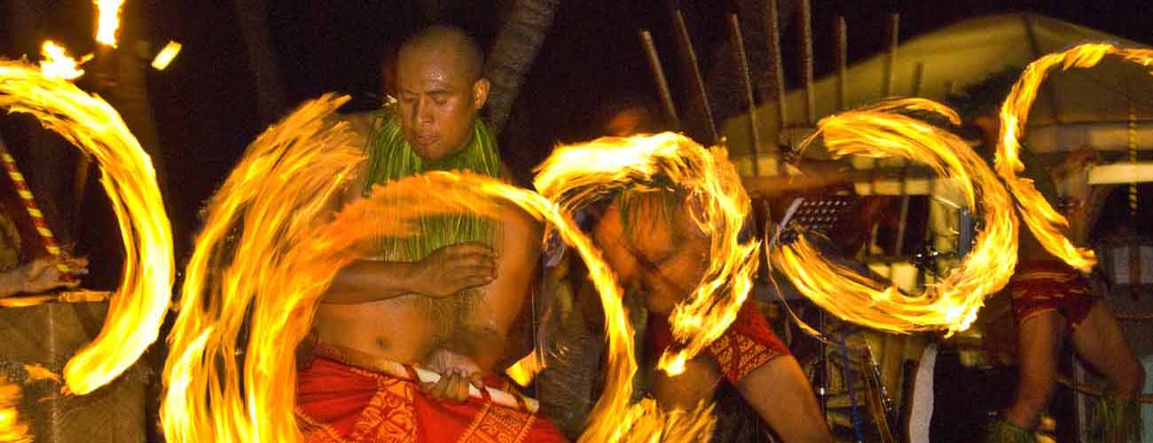 Image of five Samoan fireknife dancers performing